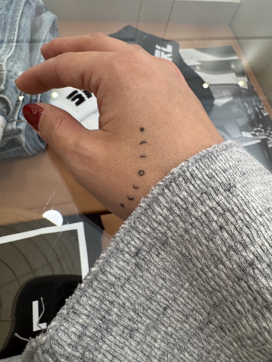 Tiny moon phase tattoo on the hand by Memi Wilson in Honolulu